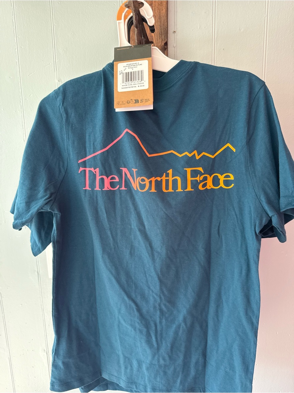 The North Face Teal Short Sleeve Tee with Pink-to-Yellow Gradient Logo